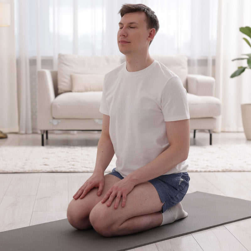 Man practicing yoga in a living room setting